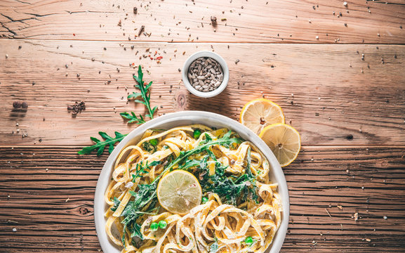 Pasta With A Sour Cream Lemon And Herbs On Wooden Table