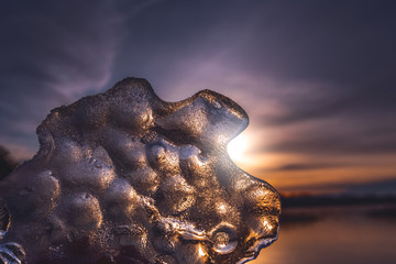 The piece of ice in the hand