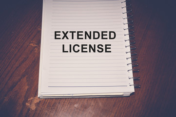 Extended license word written on white paper