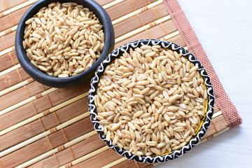 Natural oat grains, in containers for display