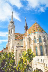 Fototapeta na wymiar Vertical photo of the Matthias Church, also known as the Church of the Assumption of the Buda Castle, in Budapest, Hungary. Amazing Gothic Cathedral in the Hungarian capital city. Tourist landmark