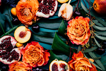Lush still life arrangement of variety of colorful fruits and flowers