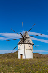old windmill traditional in Spain, Pozo de los Frailes, province of Almeria, windmill under blue sky, traditional white windmill