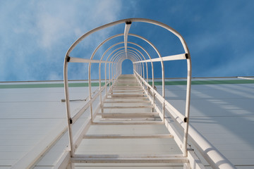 Stairway to Heaven. Religious concept. Blue sky. White metal staircase. Religious concept.