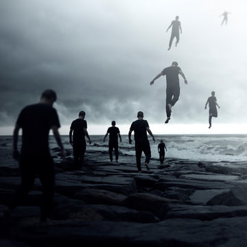 Group of people walking towards the ocean and floating away into the sky, conceptual image