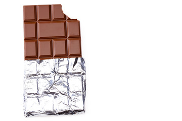 bitten milk chocolate bar in foil isolated on white background. top view