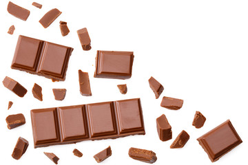 Milk chocolate pieces isolated on white background. top view