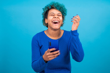 Young woman or girl with smart phone isolated on color background