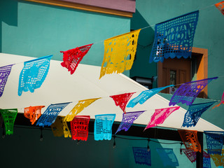 Traditional mexican banners hanging over San Antonio Mercado for October festival season