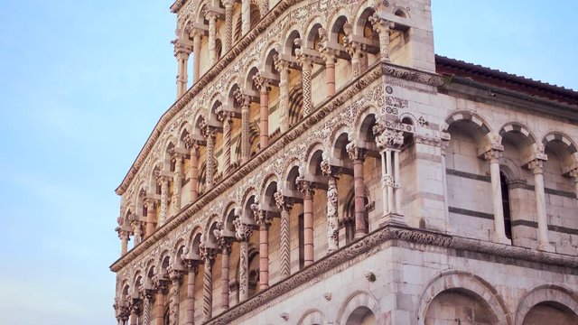 Lucca, Tuscany Italy: Facade of the cathedral of San Michele in Foro at sunset, gimbal panning 4K graded from flat, ProRes. Famous for its intact Renaissance-era city walls. Piazza San Michele