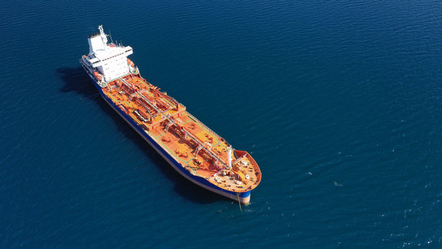 Aerial drone photo of huge crude oil tanker ship docked in industrial area of Elefsina, Attica, Greece