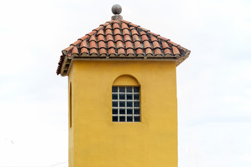 Yellow tower with red tiled roof