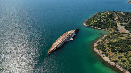 Aerial drone photo of sunk ship near shore of industrial area of Elefsina, Attica, Greece