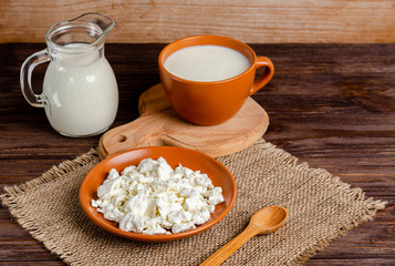 Homemade fermented milk products - kefir, cottage cheese on a wooden background