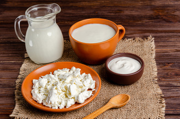 Homemade fermented milk products - kefir, cottage cheese on a wooden background