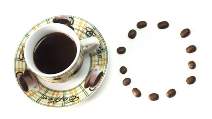 A Cup of hot coffee with scattered grains on a white table