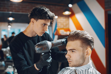 Man with a beard. Hairdresser with a client.