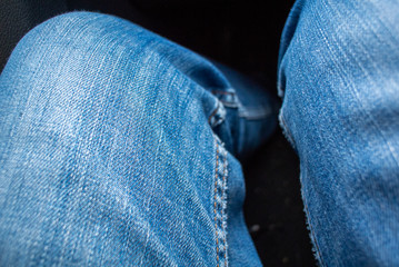 Overhead view of fashionable blue jeans pants on legs