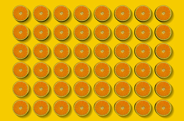 Fruit pattern of fresh orange slices on yellow background. Top view. Copy Space. Pop art