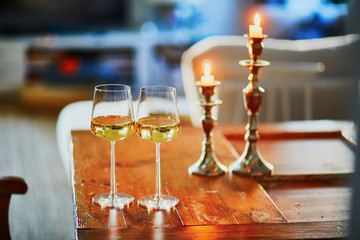 Two glasses of white wine and two candles