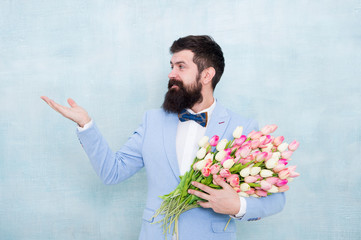 Flowers shop. Ideas to celebrate without breaking bank. Spring mood. Love date. Gift bouquet. Bearded man hipster with flower bouquet. Flower bouquet for womens day. Bearded man with tulips