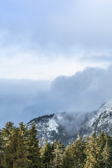 Beautiful Mountain with mist and clouds view from Grouse Mountain, Vancouver, British Columbia, Canada.