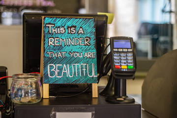 postive sign in a cafe at the counter