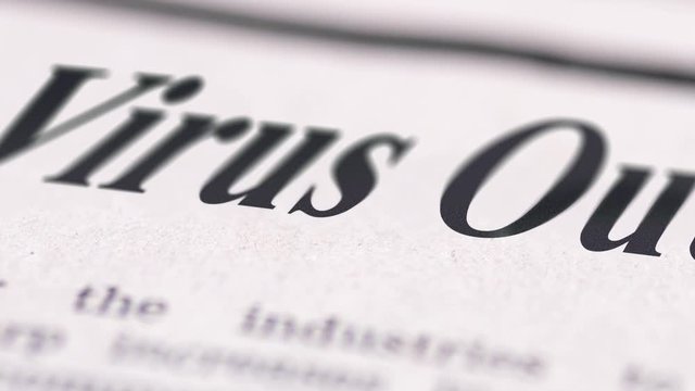 Virus Outbreak written newspaper close up footage shot to the text.