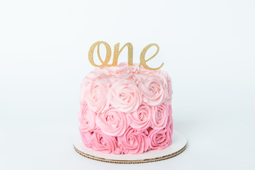 First birthday pink ombre birthday cake with a one on top as a cake topper