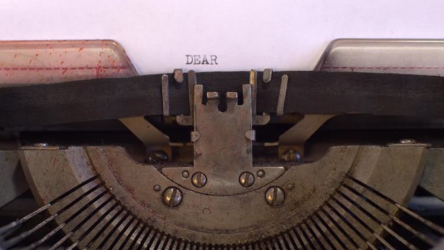 close-up typing a text DEAR MR PRESIDENT, old vintage typewriter with a sheet of paper 