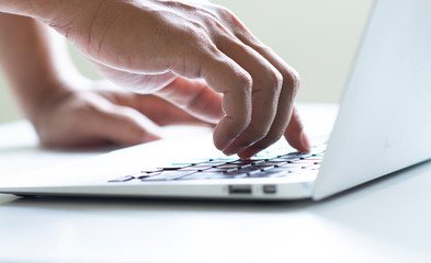 Hand man typing on computer laptop by using index finger