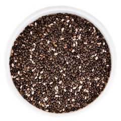 Chia seeds in a bowl isolated on a white background. Top view.