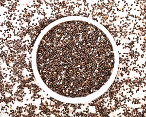 Chia seeds in a bowl on a white background. Top view.
