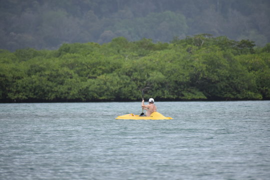 men padding on beach