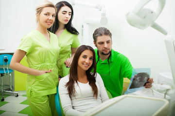 Young Dentist treating a female Patient in the dental studio