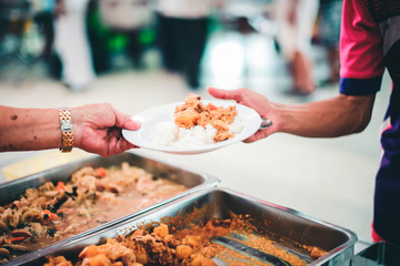 Food support for the poor, homeless hands submitting free food from volunteers