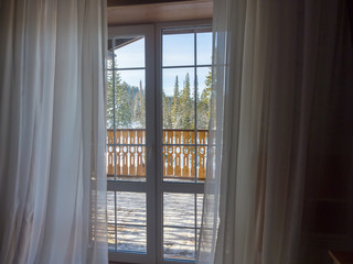 The interior in the hotel room of the ski resort Gornaya Salanga. Balcony view