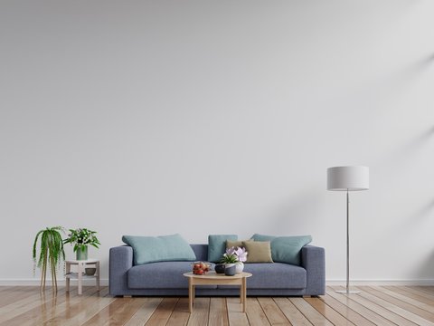 Modern living room interior with sofa and green plants,lamp,table on white wall background.