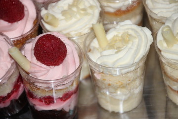 Fancy parfait desserts with raspberries, cookies and whipped cream. Yum!