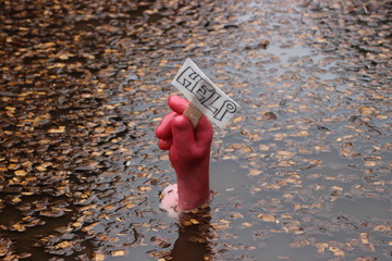 Funny sign to signify that we all need help at some time.  A hand holding a help sign sitting on...