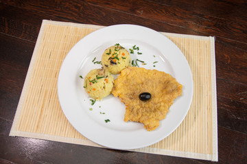 Chicken breast schnitzel with rice and olives