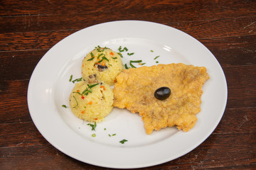 Chicken breast schnitzel with rice and olives
