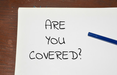 Are you covered word written on white paper