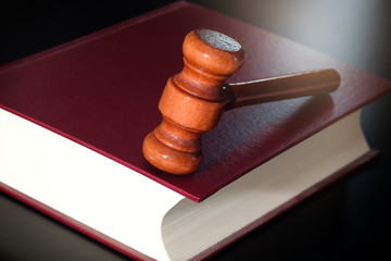 Judge's hammer Put on law books. On a black background . law concepts and protection