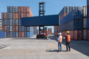 Foreman control loading containers box from cargo freight ship for import export, Foreman control...