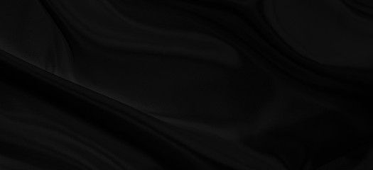 Black gray satin dark fabric texture luxurious shiny that is abstract silk cloth panorama background with patterns soft waves blur beautiful.