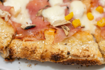 Pizza with corn and ham and sesame