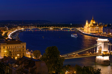 Fototapeta na wymiar Night panorama of Hungarian Parliament Building, Széchenyi Chain Bridge, and River Danube in Budapest, Hungary