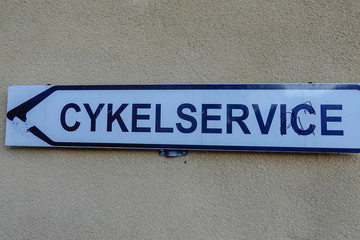 Norrtalje, Sweden A sign in Swedish giving directions to a bicycle workshop.