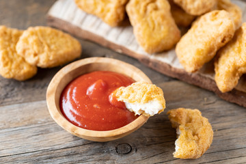 Fried crispy chicken nuggets with ketchup close-up